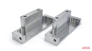 Two 3-axis CNC machined aluminum brackets with pockets, drilled holes and tapped holes