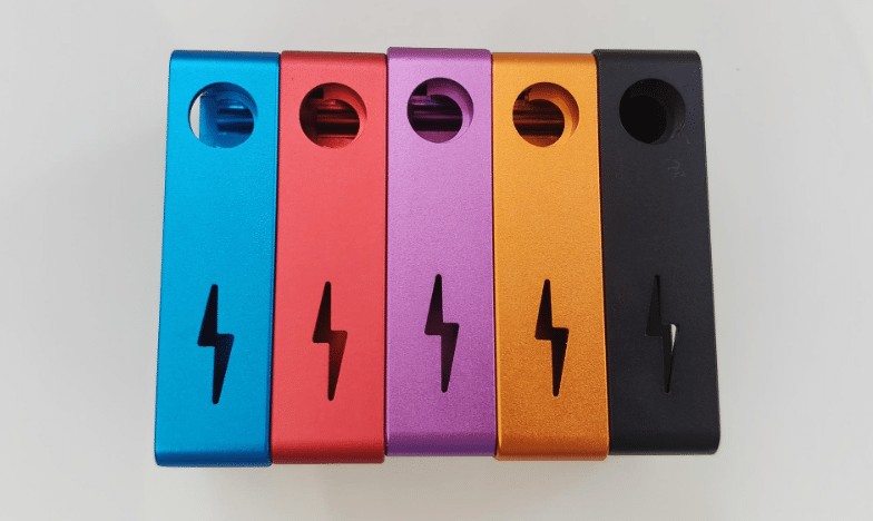 Identical aluminum parts anodized in blue, red, purple, orange, and black