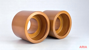 Two machined cylindrical parts finished with a copper-colored powder coating